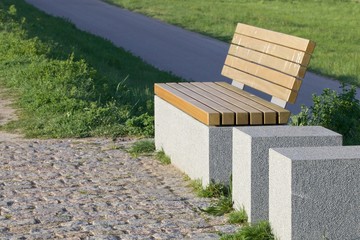 Modern bench on a grassy knoll 2