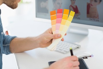 Wall Mural - Designer working with digitizer holding colour chart at his desk