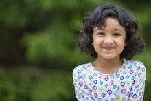 Outdoor Portrait Of A Smiling Little Girl