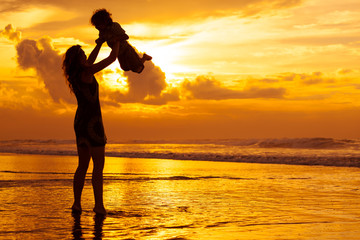 mother and  son playing on the beach