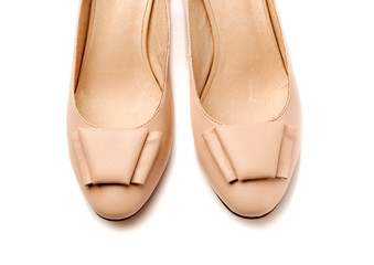 Pair of women's shoes leather beige closeup.