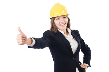 Pretty businesswoman with hard hat thumbing up   isolated on whi