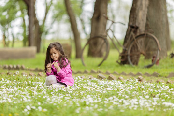 Wall Mural - Little girl at the spring field