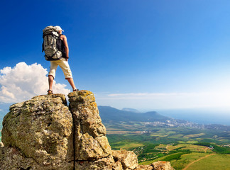 Wall Mural - Tourist on the rock. Sport and active life concept