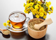 Healthy Tea, Bucket With Coltsfoot Flowers And Mortar On Table