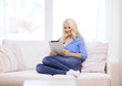 © Syda Productions - smiling woman with tablet pc computer at home