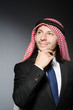 © Elnur - Arab businessman againt grey background