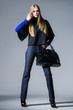 © Mee Ting - full-length fashion girl with handbag posing