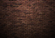 dimly lit old brick wall