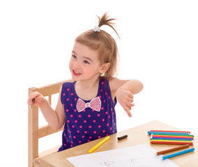 little girl with paints at the table.