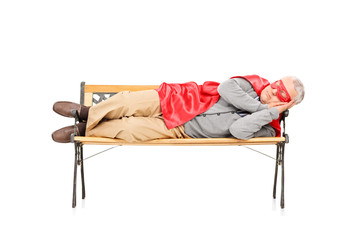 Mature man in superhero costume sleeping on bench