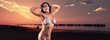 © ysbrandcosijn - Muscled fitness woman wearing bikini. On the beach at sunset. Pa
