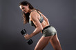 © ysbrandcosijn - Fitness woman weight lifting with dumbbells. Wearing camouflage