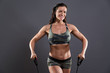 © ysbrandcosijn - Fitness woman exercising with elastics. Wearing camouflage sport