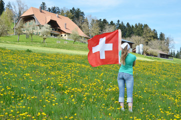 Canvas Print - Girl holding Swiss flag. Emmental, Switzerland