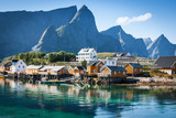 Fototapeta  - Typical Norwegian fishing village with traditional red rorbu hut