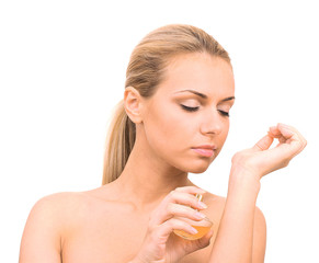 Charming young woman with perfume on white background close-up