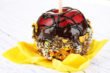 Candied Apple On Stick On Wooden Table