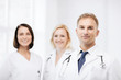 © Syda Productions - doctor with stethoscope and colleagues