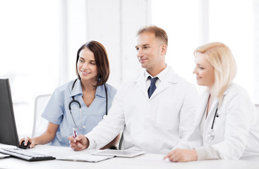 Wall Mural - doctors looking at computer on meeting