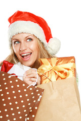 Wall Mural - young woman with Santa hat holding shopping bags