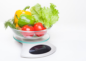 Kitchen weight scale with vegetables.