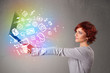 © ra2 studio - Young lady holding notebook with colorful hand drawn multimedia