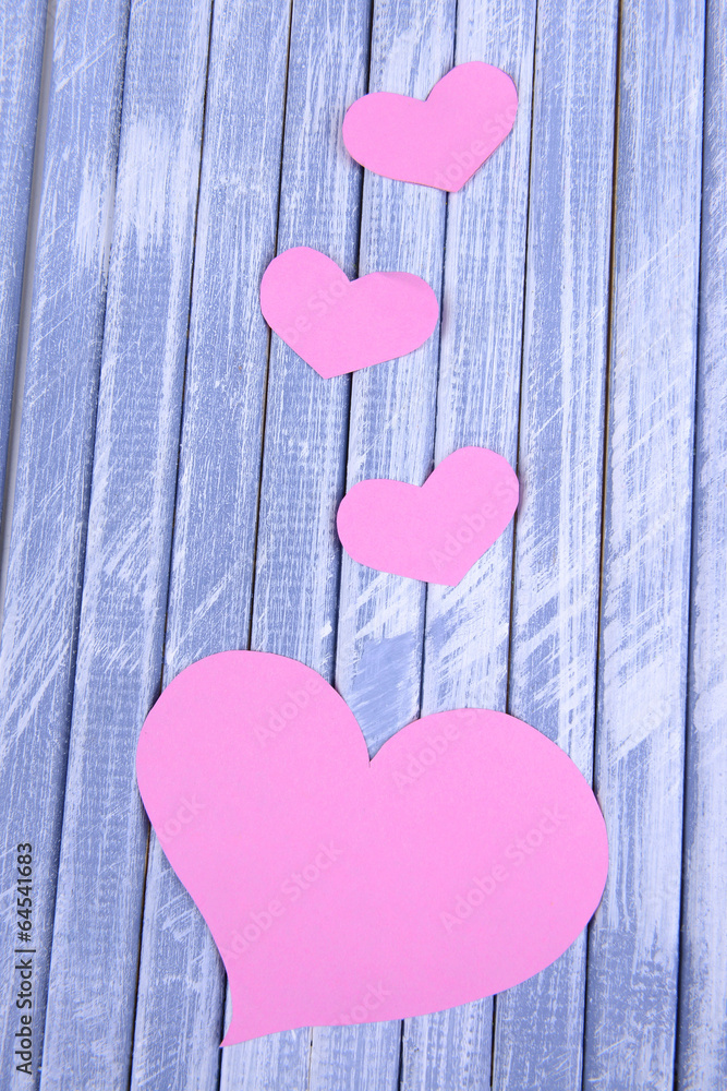 Paper hearts on wooden  background