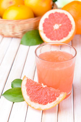 Wall Mural - Ripe grapefruit with juice on table close-up