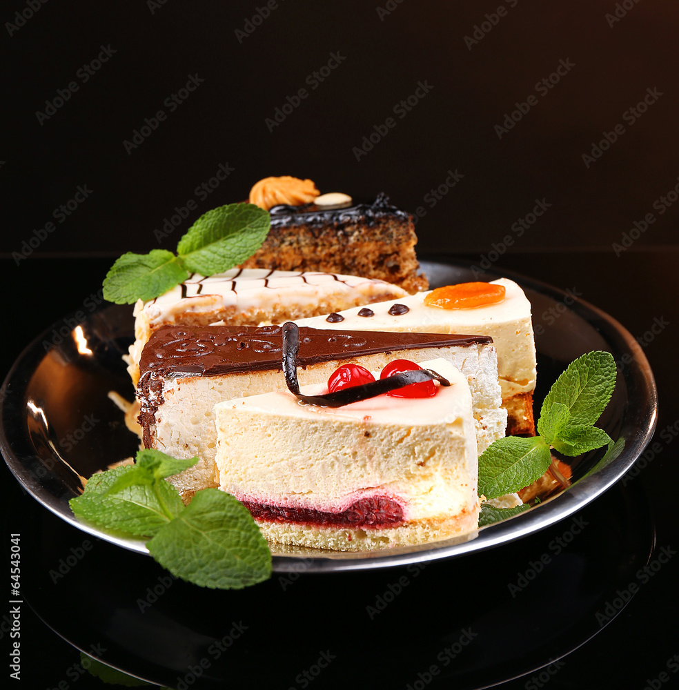 Assortment of pieces of cake, on dark background