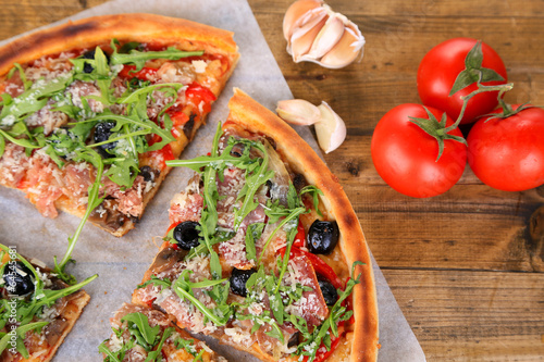 Obraz na płótnie canvas trzyczęściowy "tryptyk" Pizza z rukolą na kolor drewniane tła