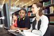 © Jacob Lund - University students studying in library with computers