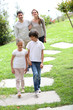 © goodluz - Happy family of four walking towards home