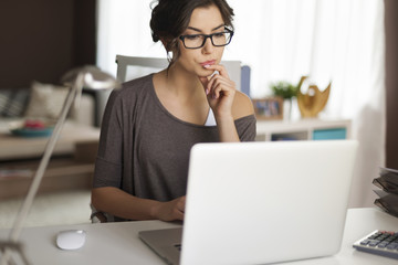 Pensive woman working at home