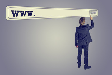 Wall Mural - man touching the button of a huge search bar