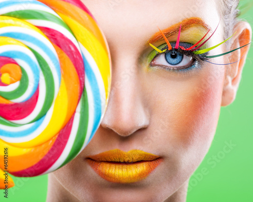 Fototapeta na wymiar Colorful twisted lollipop, colorful fashion makeup