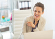 © Alliance - Laughing business woman with laptop