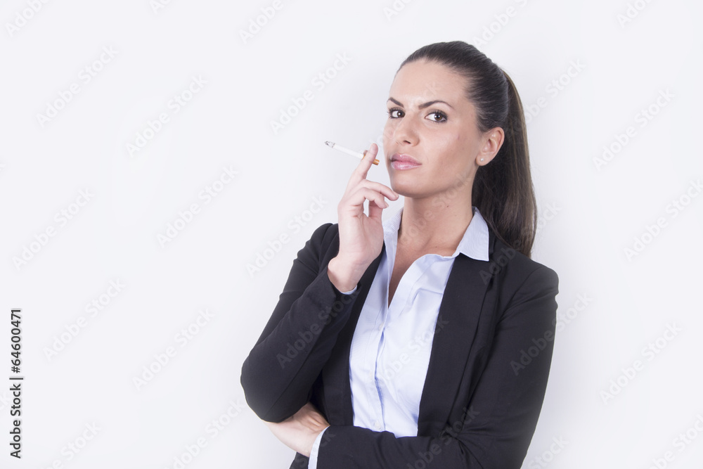 Business woman in a suit smoking a cigarette Stock Photo