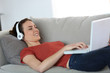 © goodluz - Woman with headphones chating on internet
