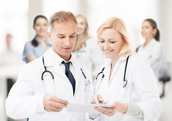 Poster - two doctors looking at tablet pc