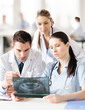 © Syda Productions - group of doctors looking at x-ray