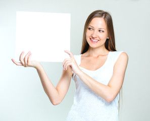 Wall Mural - young smiling woman holding blank card