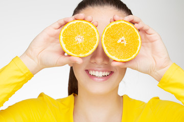 Young brunette with orange in her hand