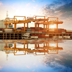 Wall Mural - Container stacks and ship under crane bridge