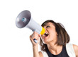 © luismolinero - Pretty girl shouting with a megaphone over white background