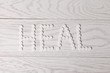 Word heal made of pills on table
