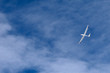 A glider flying across the blue sky
