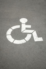 parking sign for handicapped painted on the street