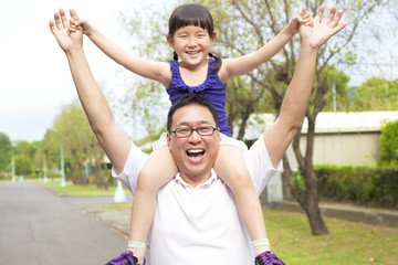 Wall Mural - happy Father and little girl with sunset background