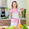 © Valua Vitaly - Happy young woman cooking a salad.